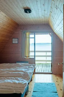 a bedroom with a bed and a large window at Nature Gem 5 Metres From Limfjord in Roslev