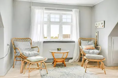 a room with two chairs and a table and a window at Skipper House With Views Of The North Sea in Harboør
