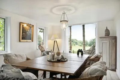 a dining room with a wooden table and chairs at Nature-Close Home Near Beach At Limfjorden in Thyholm