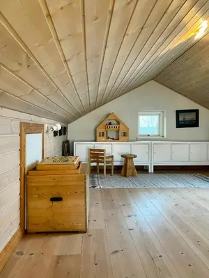 a large room with a wooden ceiling and a table at Summer House With Panoramic View Near Doverodde in Doverodde