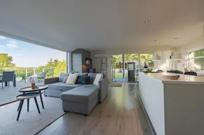 a kitchen and living room with a couch and a table at Panoramic View And Terrace In Charming Home in Højslev