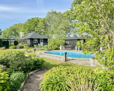 a house with a swimming pool in a yard at Relax In The Countryside With Pool in Avlum