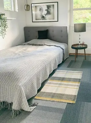 a bedroom with a bed and a table and a window at Relax In The Countryside With Pool in Avlum