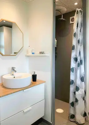 a bathroom with a sink and a shower curtain at Relax In The Countryside With Pool in Avlum
