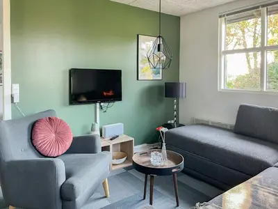 a living room with two couches and a tv at Relax In The Countryside With Pool in Avlum