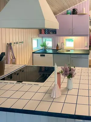 a kitchen with a counter with flowers on it at Virksund Home With Grounds And Hot Tub in Højslev