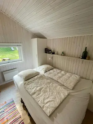 a white bed in a room with a window at Virksund Home With Grounds And Hot Tub in Højslev