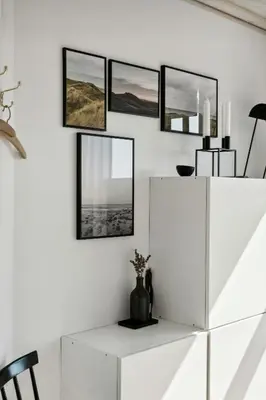 a white cabinet with four mirrors on a wall at Cozy Home By Limfjord With Bathing Jetty in Snedsted