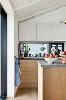 a kitchen with a bowl of fruit on a counter at Cottage At Feggeklit With Limfjord Views in Nykøbing Mors