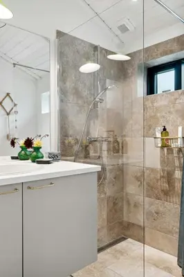 a bathroom with a shower and a white sink at Cottage At Feggeklit With Limfjord Views in Nykøbing Mors