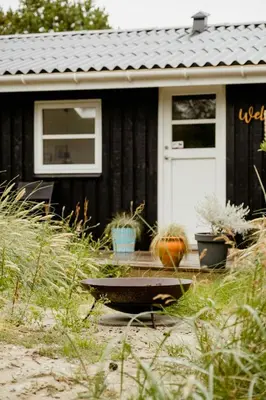 a house with a pumpkin sitting in front of it at Bright And Lovely Summerhouse In Løkken in Løkken