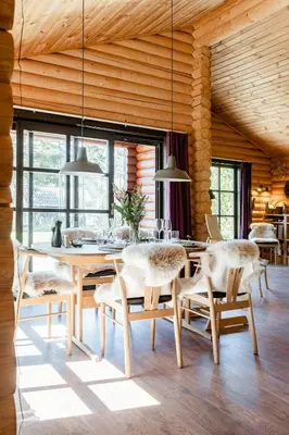 a dining room with a table and chairs at Authentic Log House Amid Evergreens In Vendsyssel in Fjerritslev