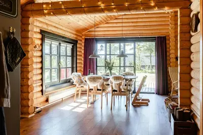 a dining room with a table and chairs at Authentic Log House Amid Evergreens In Vendsyssel in Fjerritslev