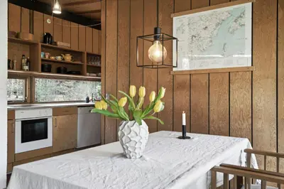 a kitchen with a table with a vase of flowers on it at Authentic Friis & Moltke House In Lundo's Nature in Højslev