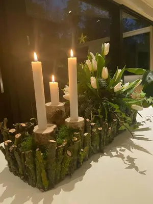 a centerpiece with candles and flowers on a table at Summer House At Thyholm With Fjord View in Thyholm