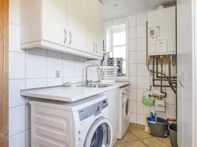 a kitchen with a washing machine and a sink at Charming Retreat in Blokhus - By Traum Ferienwohnungen in Blokhus