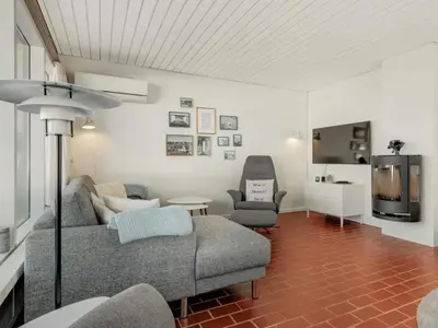a living room with a couch and two chairs and a tv at Charming Retreat in Rodhus - By Traum Ferienwohnungen in Pandrup
