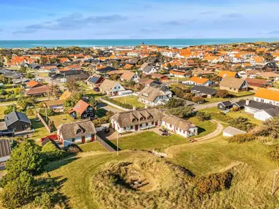 an aerial view of a town with houses and the ocean at Cozy Family Retreat - By Traum Ferienwohnungen in Blokhus