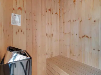 a trash can sitting next to a wooden wall at Green Oasis near Blokhus - By Traum Ferienwohnungen in Blokhus