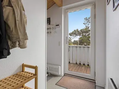 a door leading into a room with a balcony at Green Oasis near Blokhus - By Traum Ferienwohnungen in Blokhus