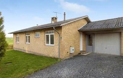 a brick house with a garage in front of it at 2 Bedroom Nice Home In Roslev in Roslev