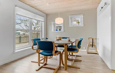 a dining room with a table and blue chairs at 4 Bedroom Awesome Home In Thisted in Thisted