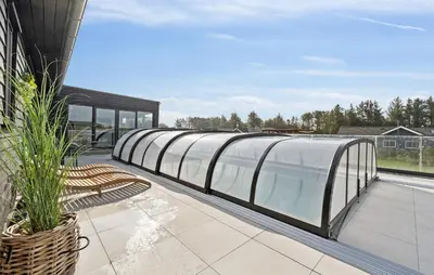 a building with a swimming pool on a roof at Stunning Home In Spøttrup With Sauna in Spottrup