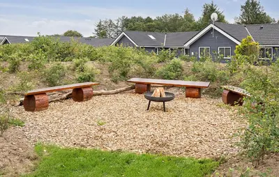 a picnic table and benches in a yard at Stunning Home In Spøttrup With Sauna in Spottrup