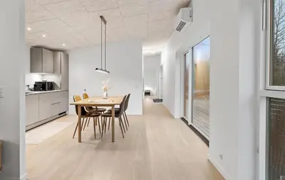 a kitchen and dining room with a table and chairs at 2 Bedroom Pet Friendly Home In Vemb in Vemb