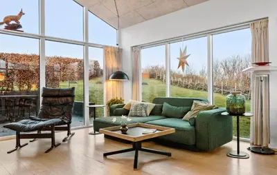 a living room with a green couch and a chair at Gorgeous Home In Nibe With Wifi in Nibe