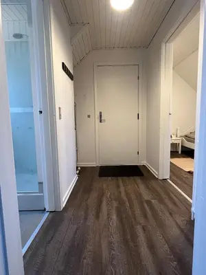 an empty hallway with white walls and wood floors at Perfect space for you and your colleague in Vinderup