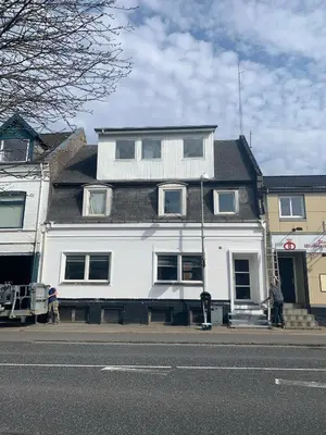 a white house on the side of a street at Perfect space for you and your colleague in Vinderup