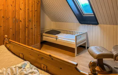 a bedroom with a bunk bed in a attic at Awesome Home In Øster Assels With Wifi in Øster Assels