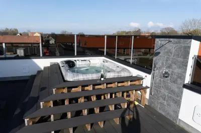a hot tub on the roof of a building at Birkelse Hotel og Kro in Birkelse