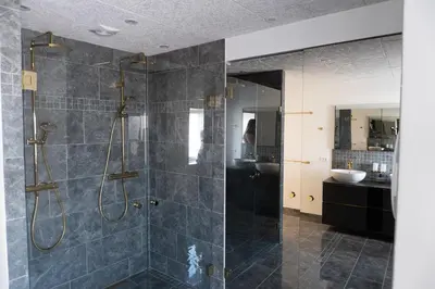 a bathroom with a shower and a sink at Birkelse Hotel og Kro in Birkelse