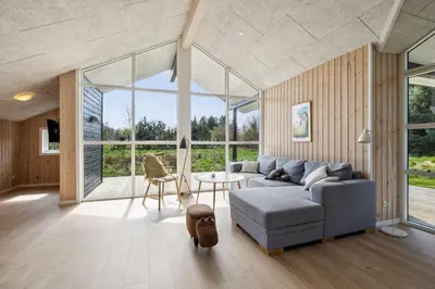 a living room with a couch and a table at Modern Holiday Home From 2017, Located At Lild Strand in Frøstrup