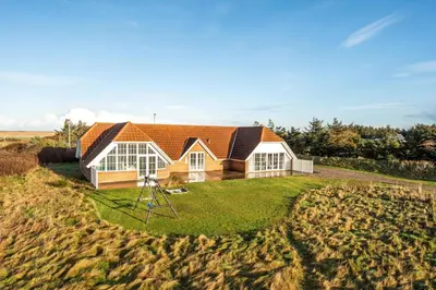 a house in the middle of a field at Family-Friendly Holiday Home With Pool, Located Close To The North Sea In Vrist in Harboør