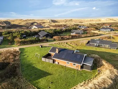 an aerial view of a house with solar panels on it at Lovely Holiday Home With Pool, Spa And Sauna, Only 200 Meters From The North Sea in Harboør