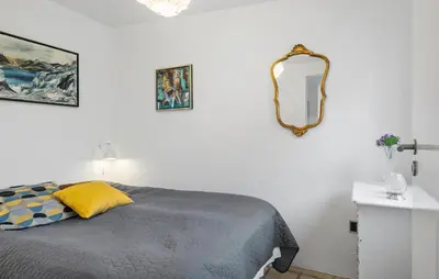a bedroom with a bed and a mirror on the wall at Cozy Home In Thyborøn With Wifi in Thyborøn