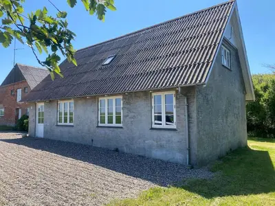 a brick house with windows on the side of it at Jørgen's Feriehus in Lemvig