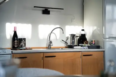 a kitchen with a sink and a refrigerator at Hotel Palads Apartments in Viborg