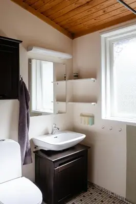a bathroom with a sink and a mirror at Authentic Family Summer House At The Limfjord in Roslev