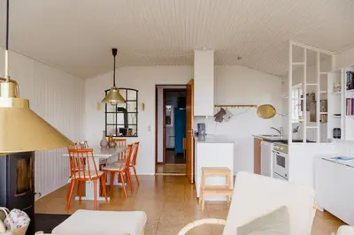 a kitchen and dining room with a table and chairs at Summer House With Panoramic Views Of The Limfjord in Lihme