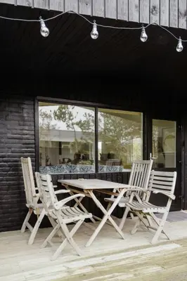 a wooden table and chairs on a patio at Experience 
