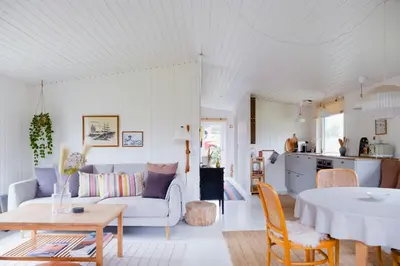 a living room with a couch and a table at Experience 