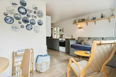 a living room with blue and white plates on the wall at Lifestyle Near Sea And Town in Nykøbing Mors