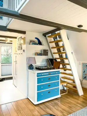 a kitchen with a blue cabinet and stairs at Summerhouse By The North Sea in Vestervig