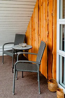 two chairs and a table on a porch at Family Summer House Close To The North Sea in Vestervig