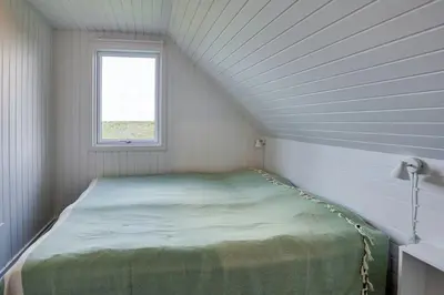 a bed in a room with a window at Family Summer House Close To The North Sea in Vestervig