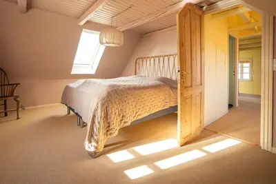 a bedroom with a bed and a window at Historic Fisherman's Gem With Twist In Klitmøller in Torsted